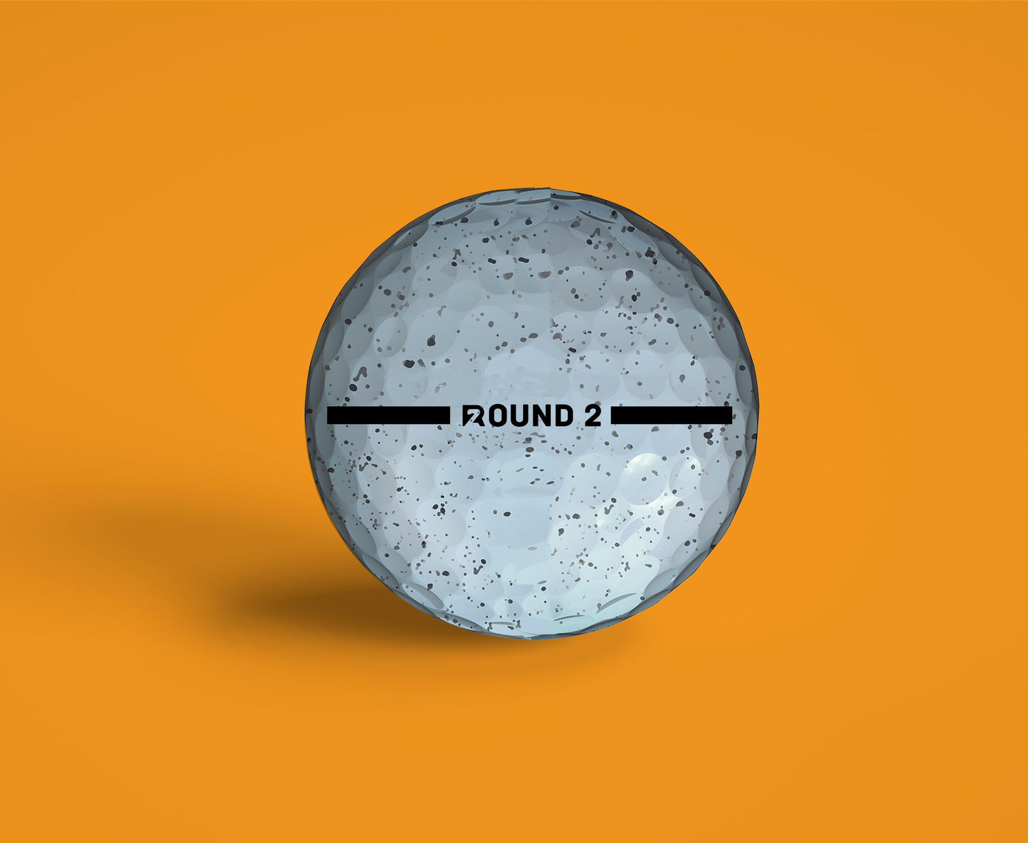 ROUND2 golf ball with alignment lines for easy aiming, designed for maximum feel, distance, and control on an orange background